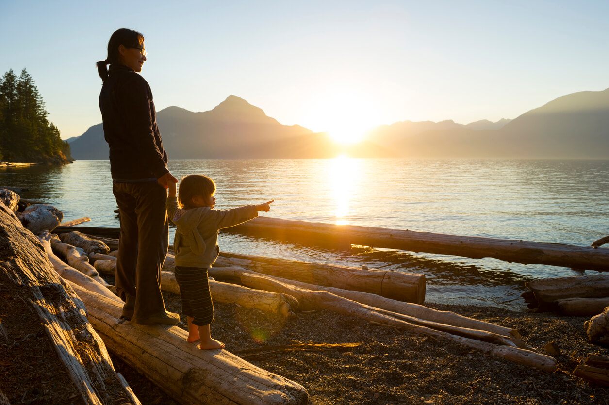 parent and child admiring lake view